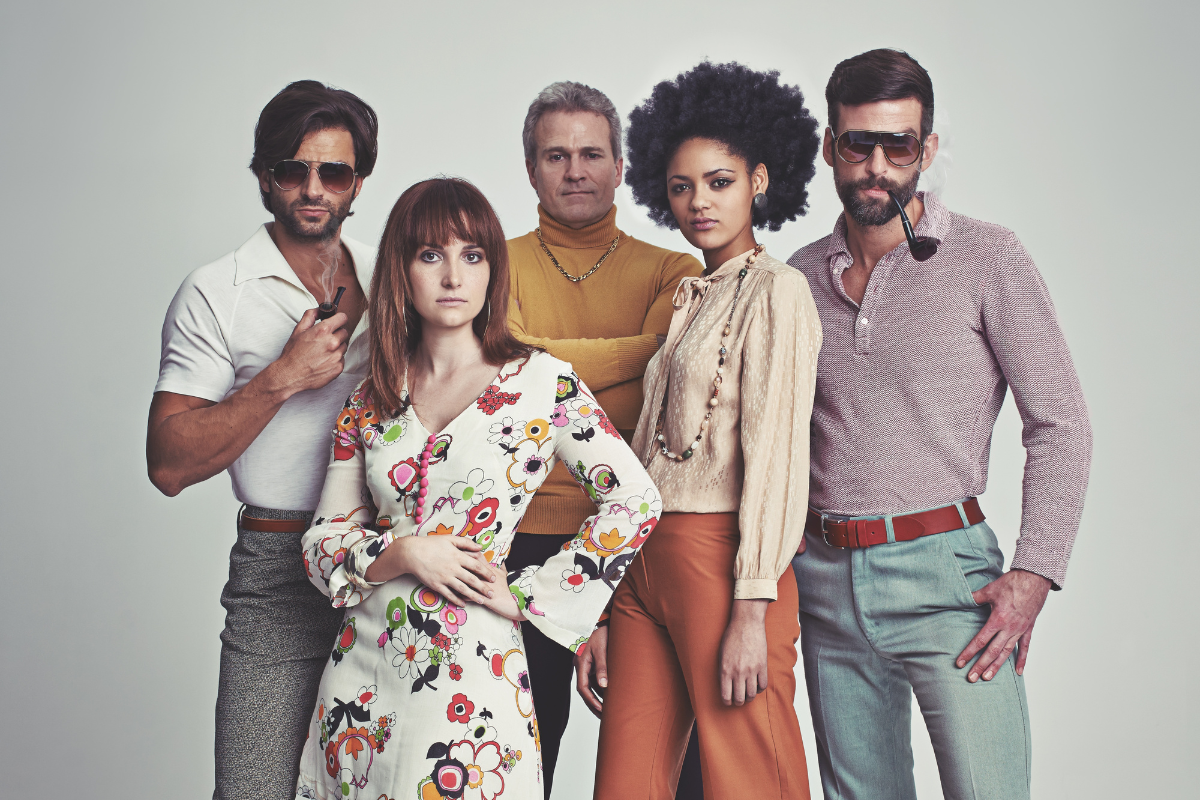A group of 70s inspired people posing together.
