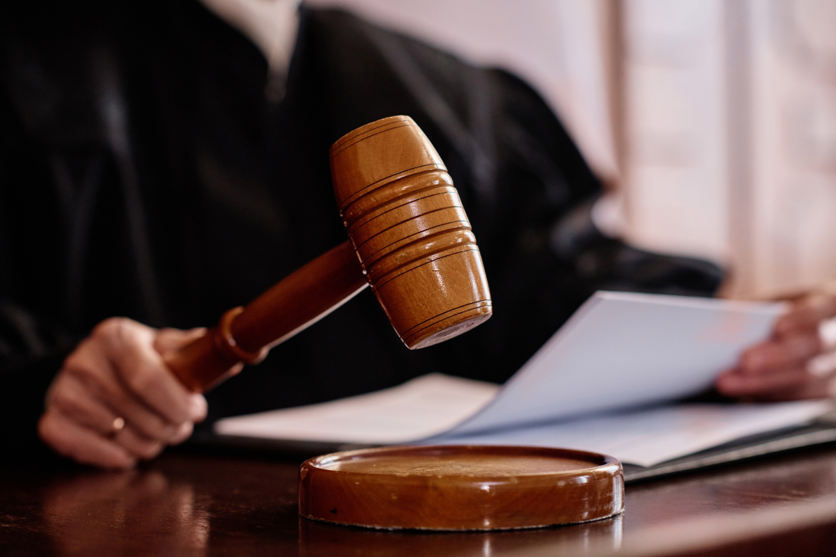 A judge holding a wooden gavel.