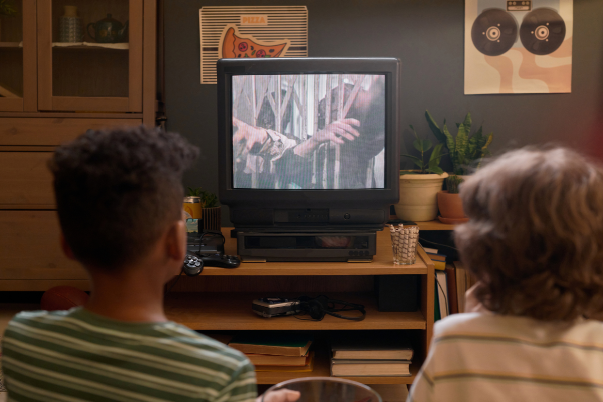 Two kids watching TV.