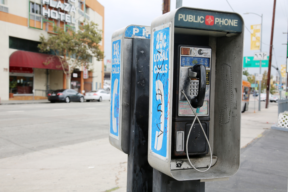 A payphone on a street.