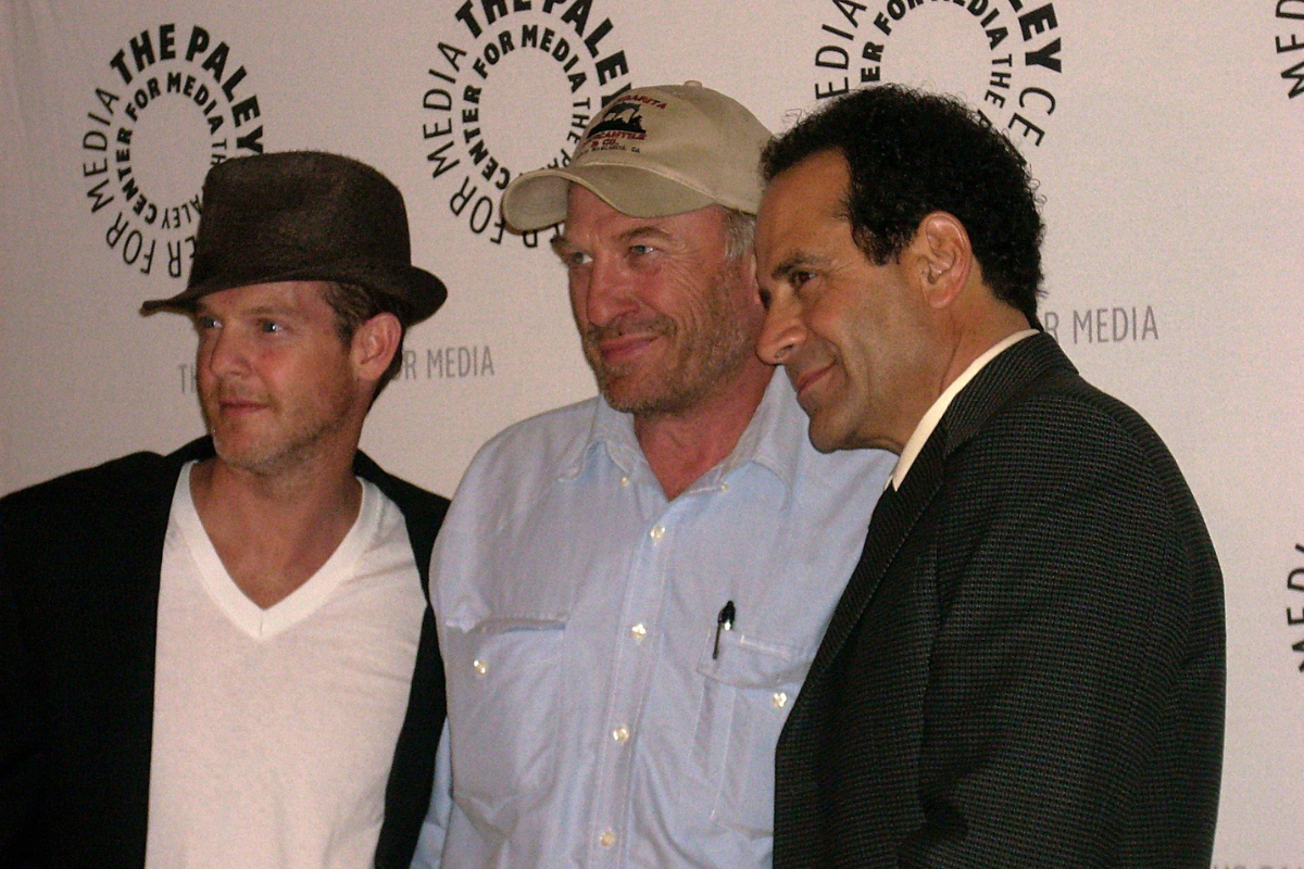 Ted Levine posing with others on a red carpet.