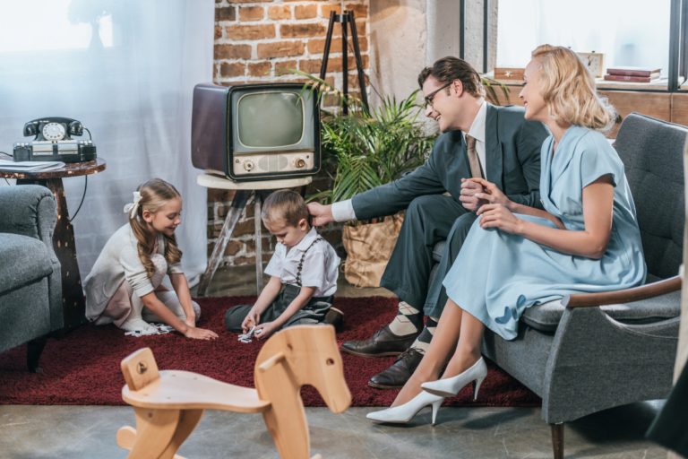 A family dressed in 1970s attire spending time in the living room.