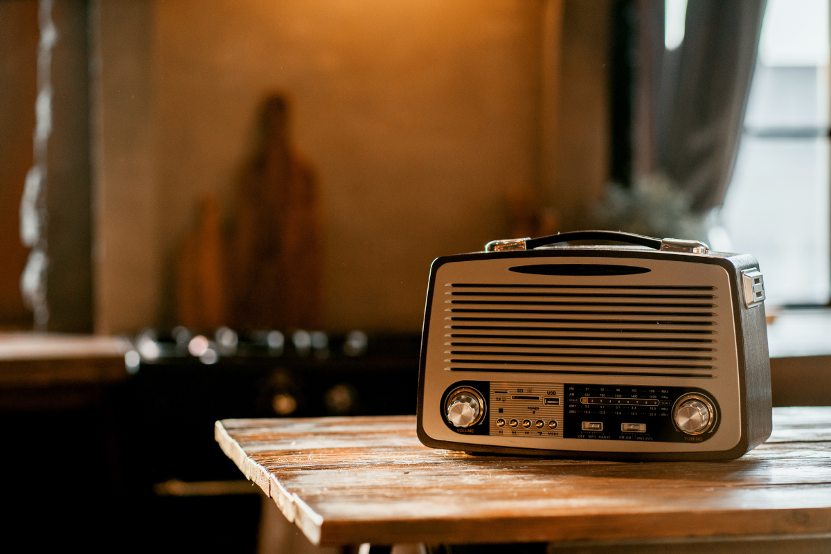 An old radio on a counter top.