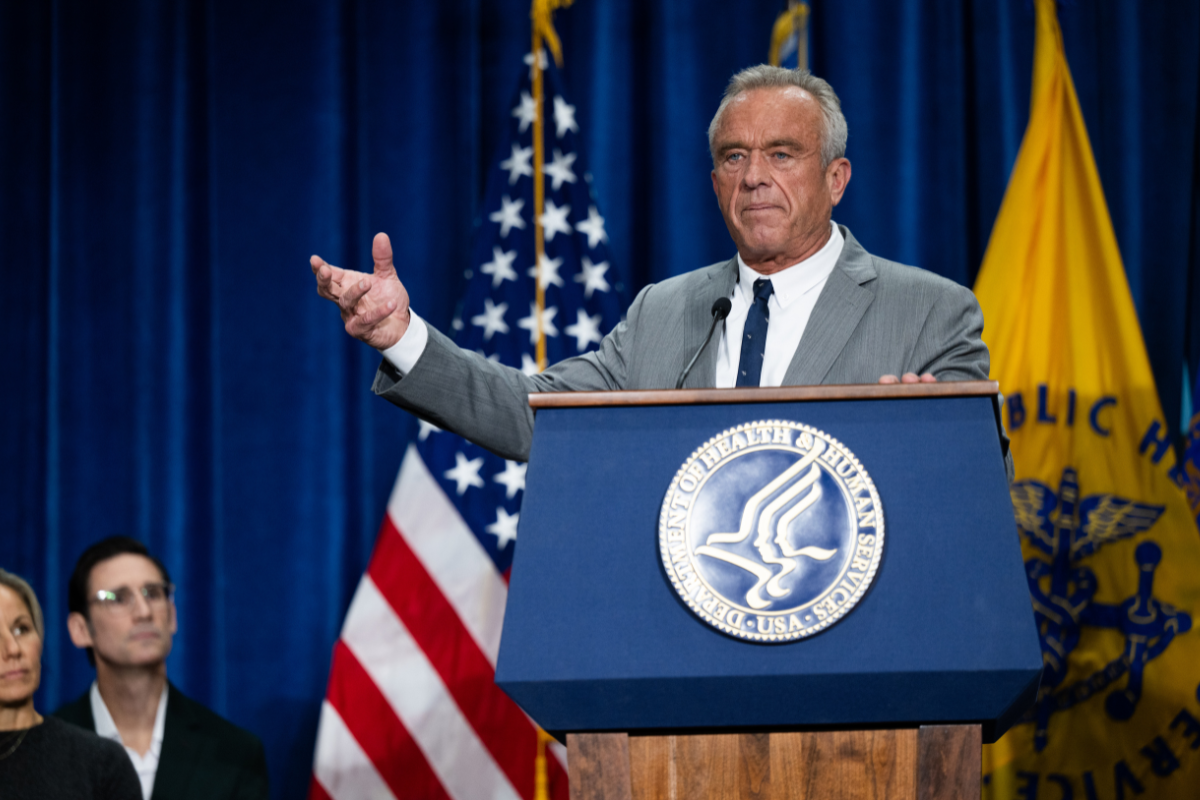 RFK Jr speaking in front of a podium.