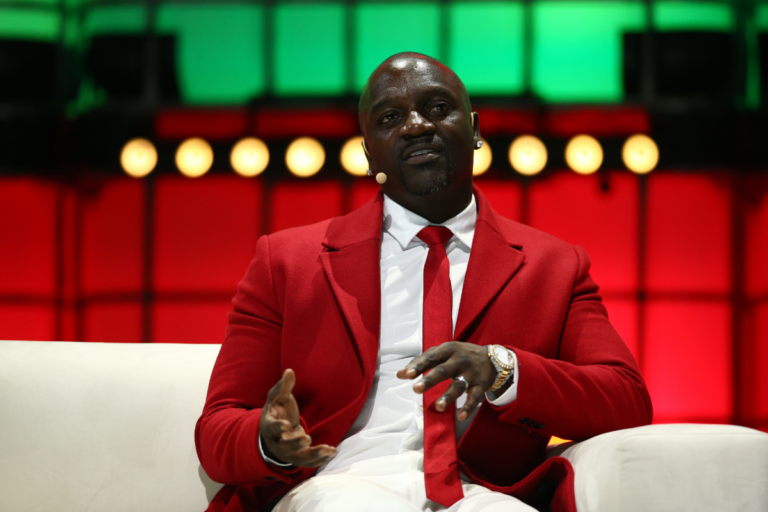 Akon speaking at an event.