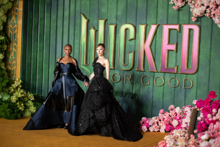 Ariana Grande and Cynthia Erivo on a red carpet.