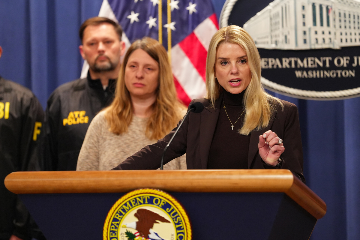 Pam Bondi speaking in front of a podium.