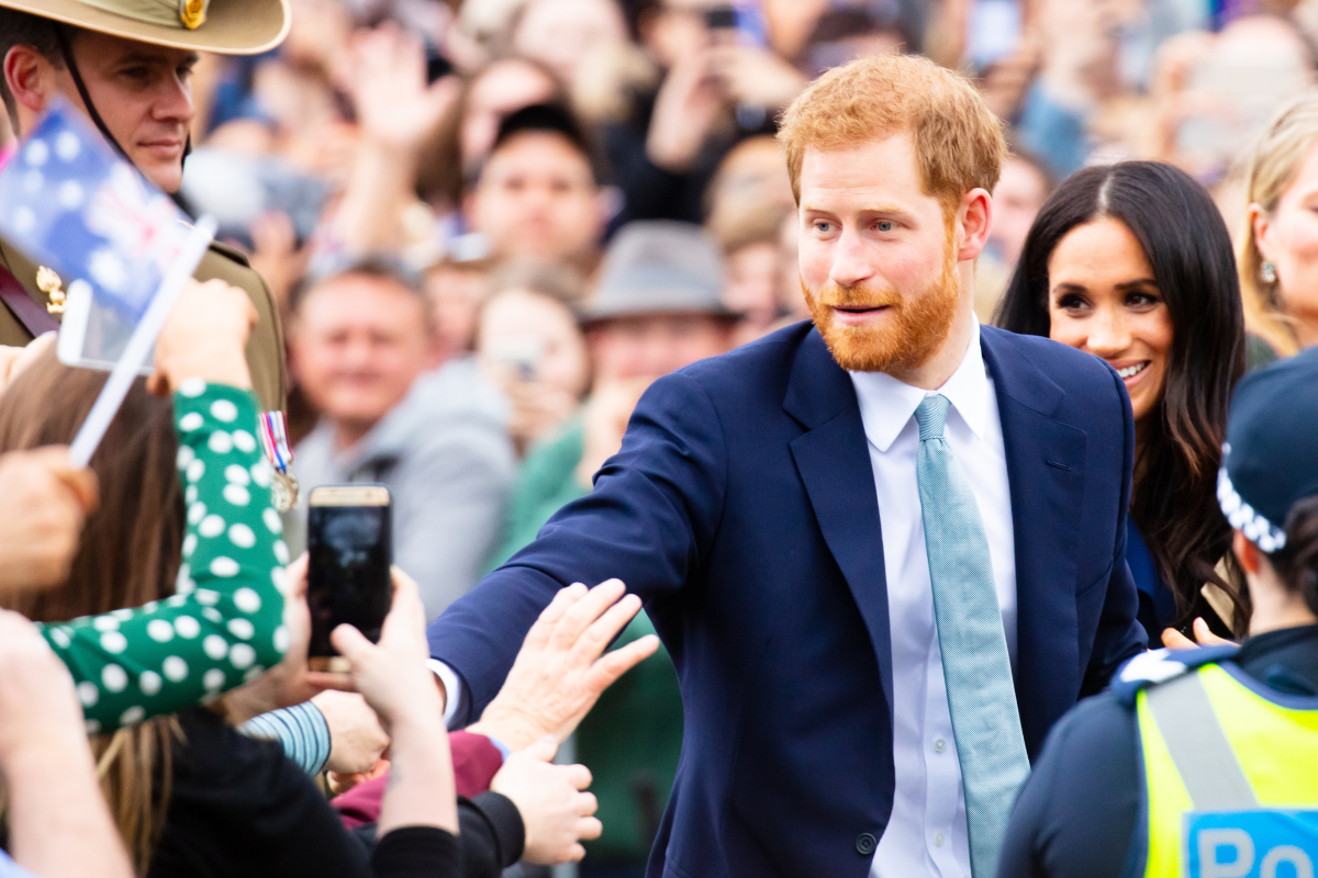 Prince Harry and Meghan in a crowd of people.