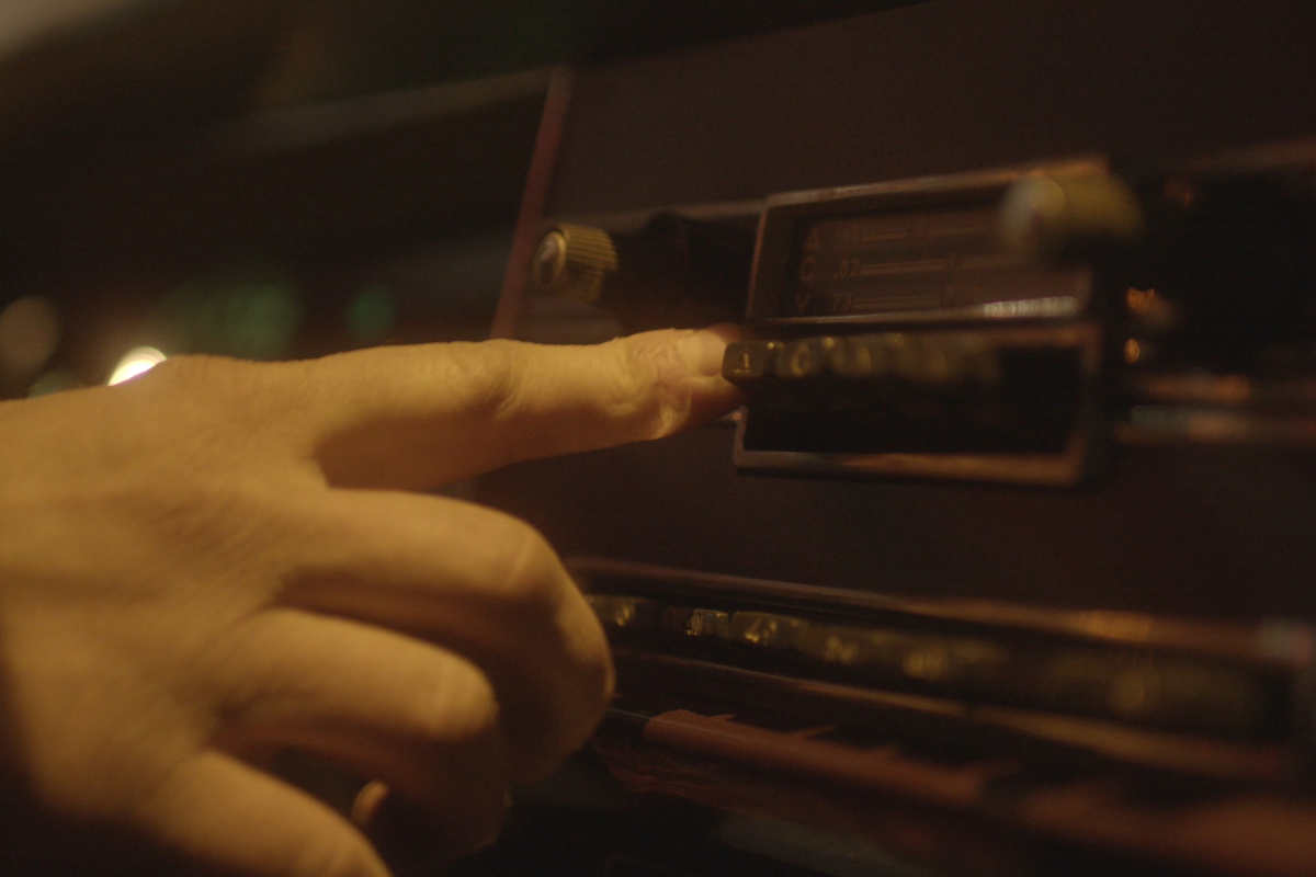 A close up image of an old car radio.