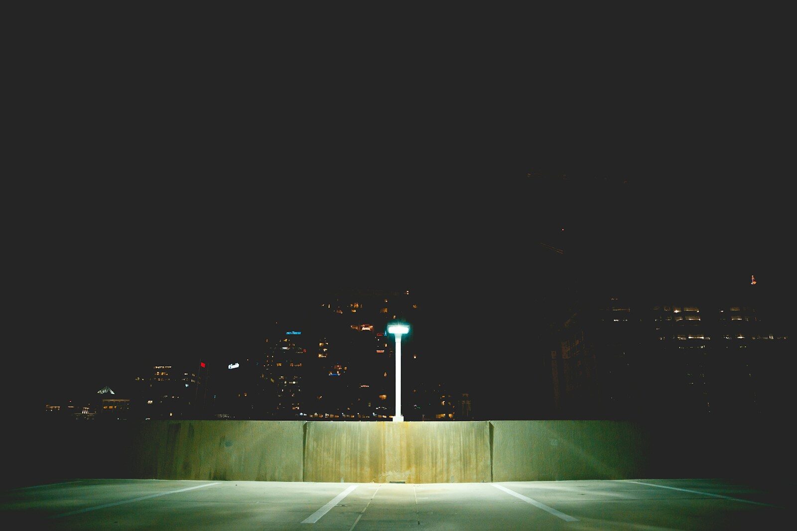 an empty parking lot at night with a street light