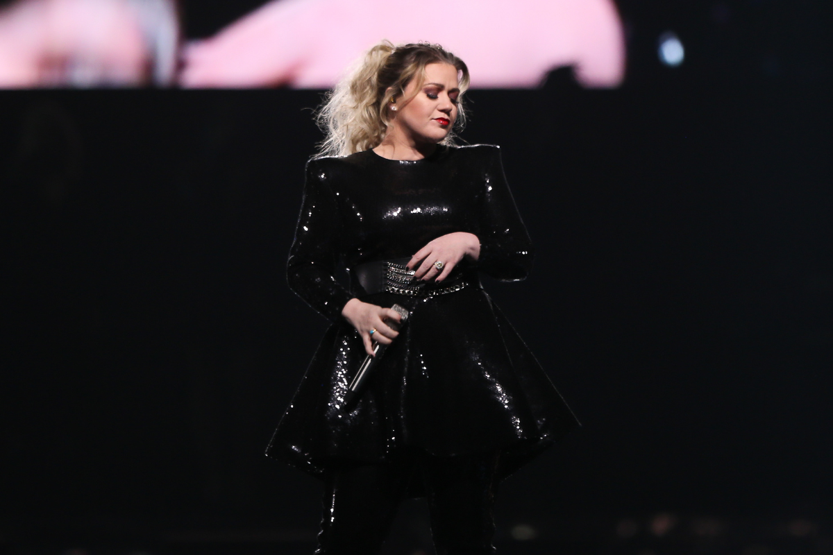 Kelly Clarkson performing live on stage.